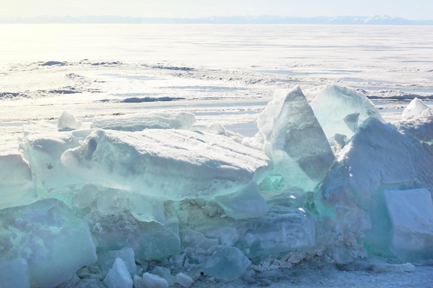 Blue ice clear transparent hummocks on the frozen lake