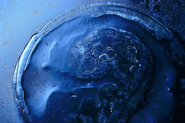 blue ice glass background, abstract texture of the surface of the ice on the glass, frozen seasonal water