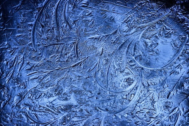 blue ice glass background, abstract texture of the surface of the ice on the glass, frozen seasonal water