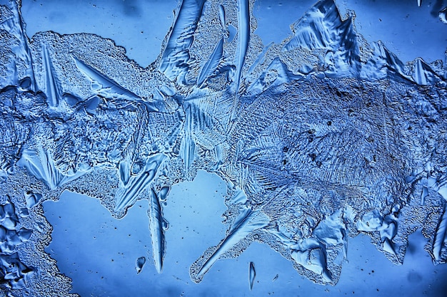 blue ice glass background, abstract texture of the surface of the ice on the glass, frozen seasonal water