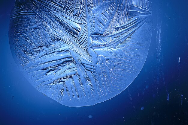 blue ice glass background, abstract texture of the surface of the ice on the glass, frozen seasonal water