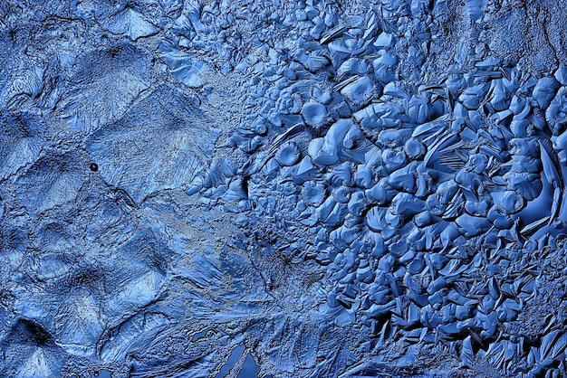 blue ice glass background, abstract texture of the surface of the ice on the glass, frozen seasonal water