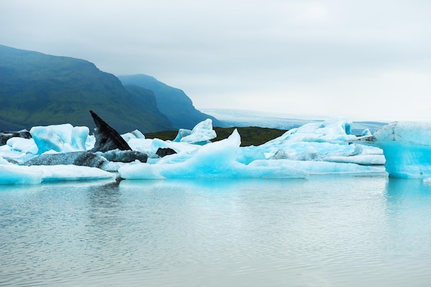 Blue icebergs in Fjallsarlon glacial lake in southern Iceland