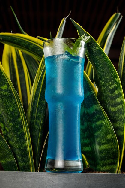 Blue iced cocktail with lime and mint