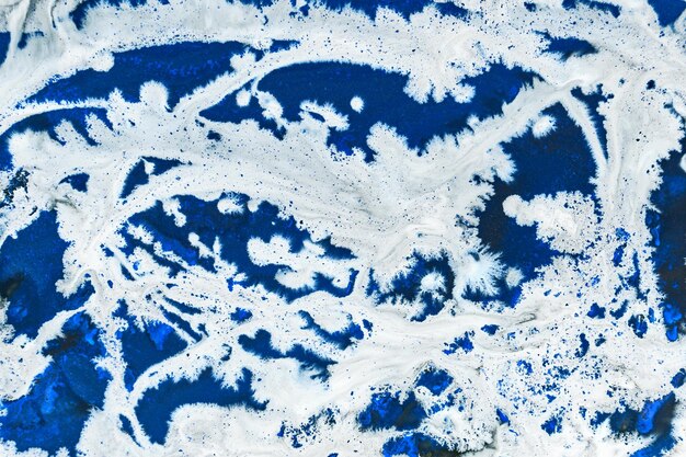 Photo blue ink abstract background winter paint pattern under water acrylic pigment stains splashes and streaks