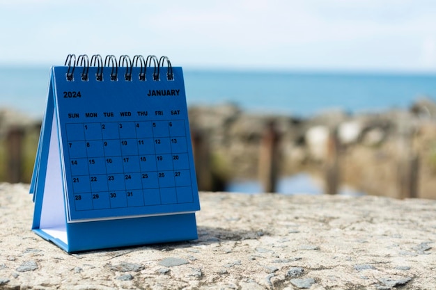 Blue january 2024 calendar on blurred background of blue ocean 2024 new year concept