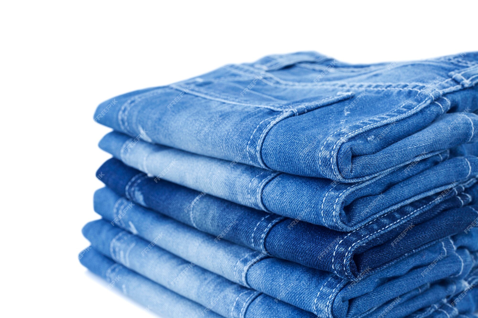 Premium Photo | Blue jean folded in a pile isolated on white background