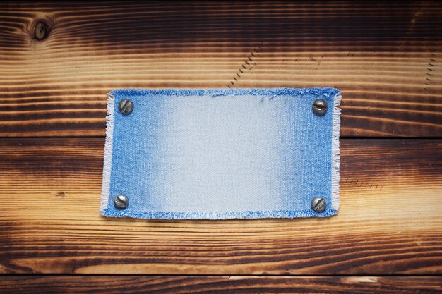 Blue jeans texture on wooden background surface