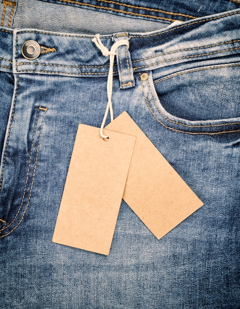 Blue jeans with a brown paper tag on a rope