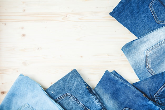 Blue jeans on a wooden background Copy Space Top view