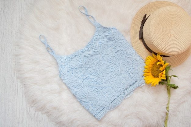 Blue lace top, straw hat and sunflower