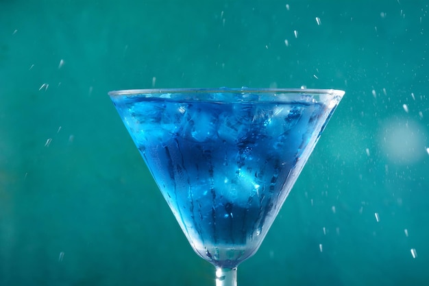 Blue lagoon cocktail with blue curacao liqueur vodka lemon juice and soda decorated with lemon slice and mint leaves