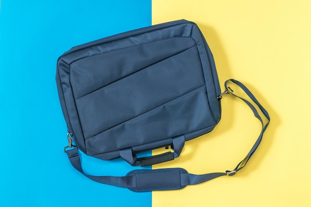 Blue laptop bag on a yellow and blue background. Accessory for your laptop.