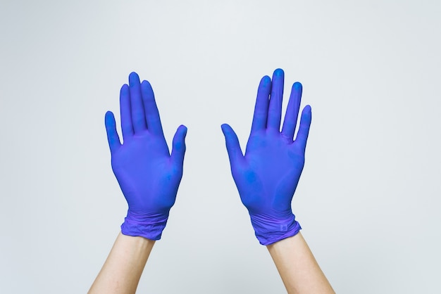 Синие латексные перчатки на сером фоне