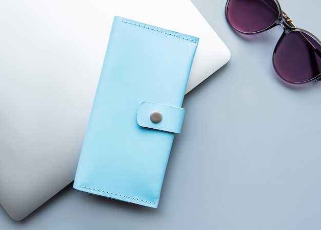 Blue leather wallet on a grey surface