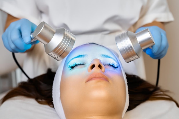 Photo blue led light therapy for the beauty of facial skin in a cosmetic salon