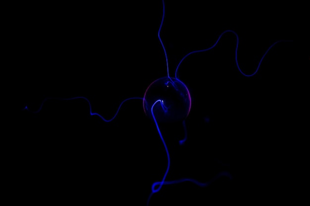 Photo blue light bulb in a black background