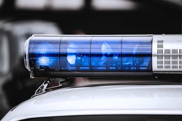 Blue light on top of a police car