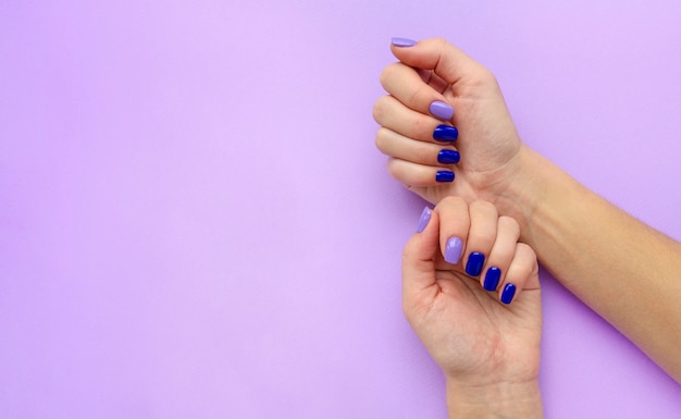 Blue and lilac manicure on woman's hands