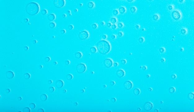 Bolle e trame astratte liquide blu del fondo dell'acqua su un fondo blu