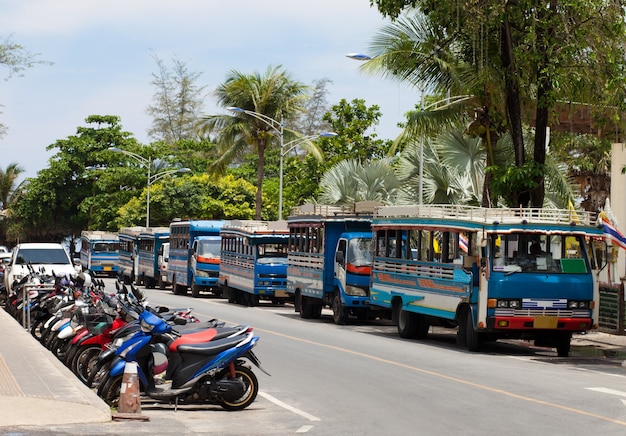 Blue local bus and motorbikes in Phuket Thailand