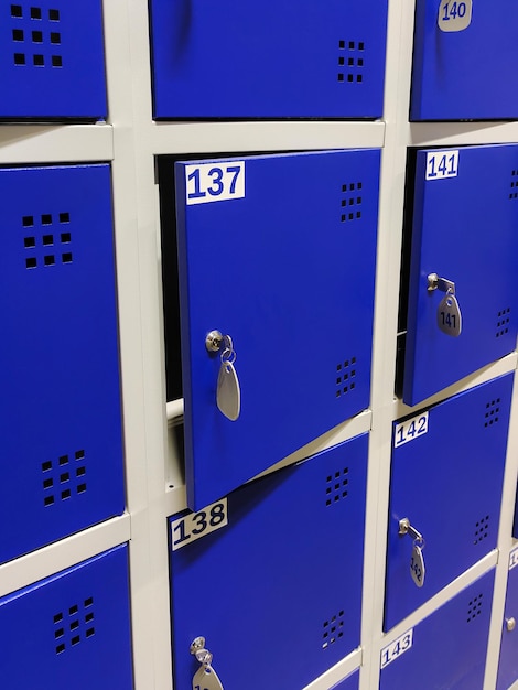 Blue lockers in a public changing room or in a clothing store a\
storage room in a supermarket