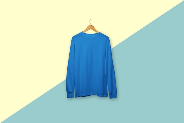 Blue long sleeve tshirt on wooden hanger isolated on background