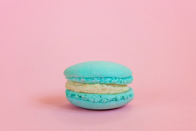 Blue macaron on pink background