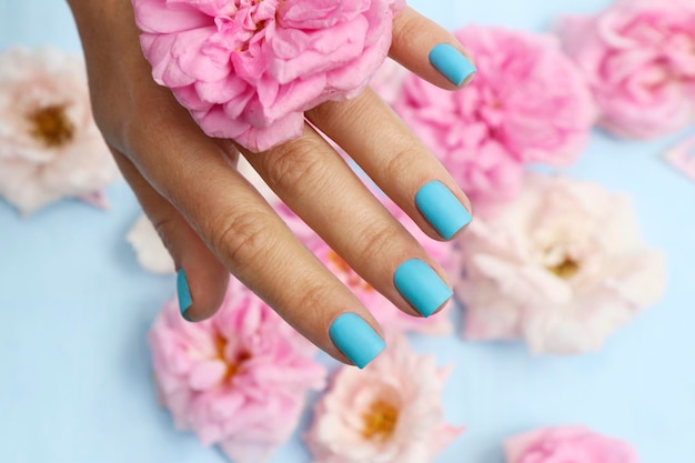 Blue manicure on short nails with pink roses.