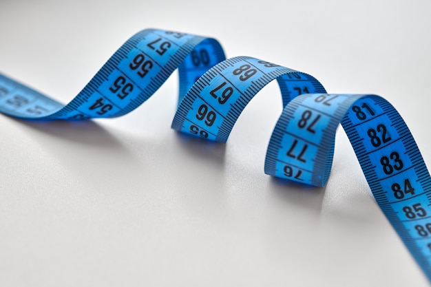 Blue measuring tape isolated on white background.