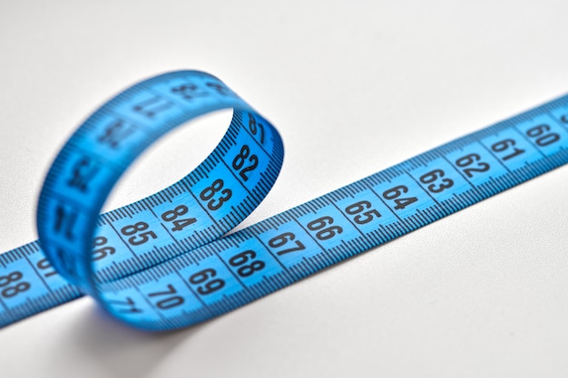 Blue measuring tape of tailor isolated on white background.