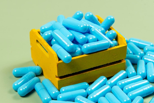 Blue medicine capsule in miniature shopping cart
