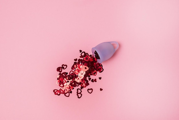 Blue Menstrual Cup Filled with Red Confetti Imitate Flow Blood