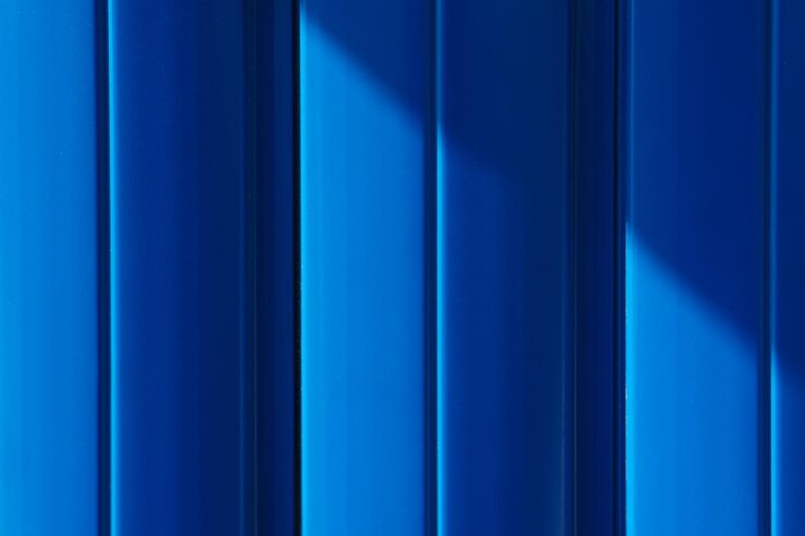 Blue metal fence illuminated by sunlight