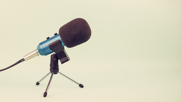 Blue microphone with wire on stand in vintage style. Equipment for Studio and concerts.