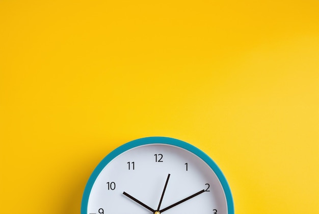 Blue modern clock on yellow color background