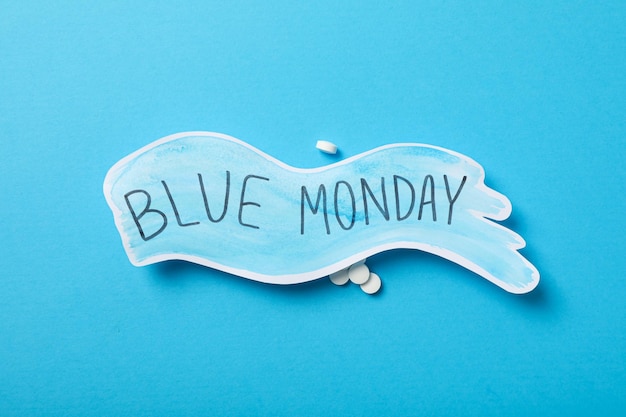 blue monday text and pills on blue background top view