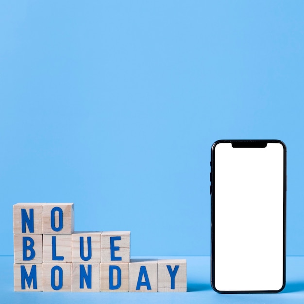 Blue monday with wooden cubes and smartphone