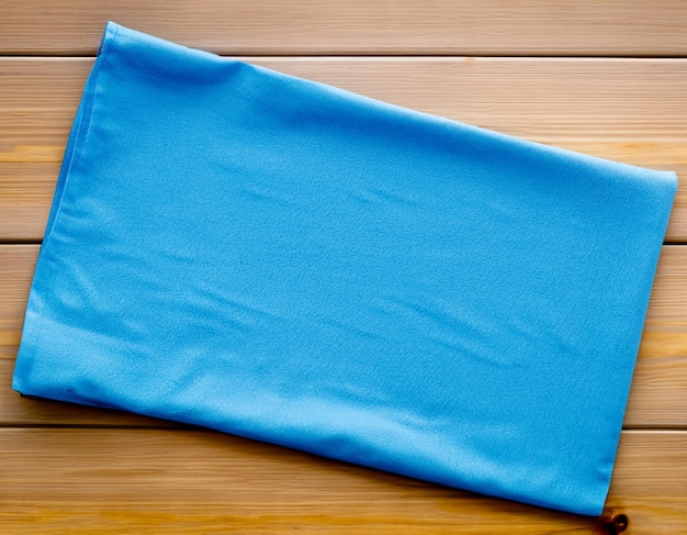 Blue Napkin on wooden table top view