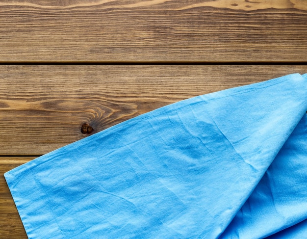 Blue Napkin on wooden table top view