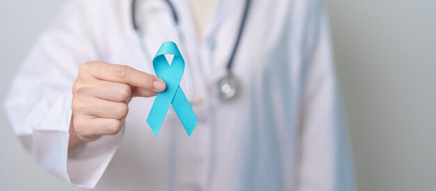 blue november prostate cancer awareness month doctor with blue ribbon in hospital for