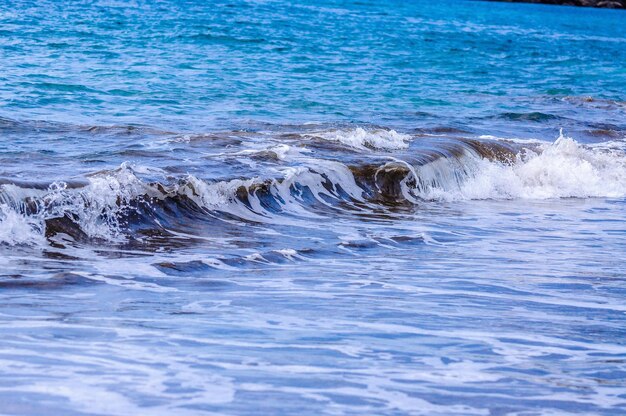 Blue ocean wave with splashes Tenerife Canary Islands