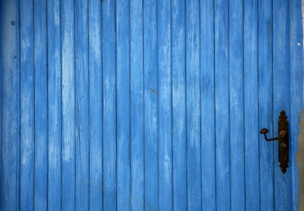 Blue old wooden door detail with handle background