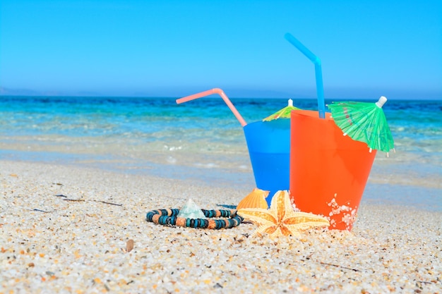 Blue and orange drinks by the sea