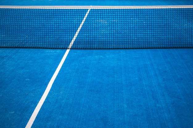 Blue paddle tennis net and court field background