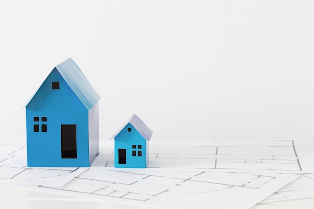 Blue paper houses on wooden table