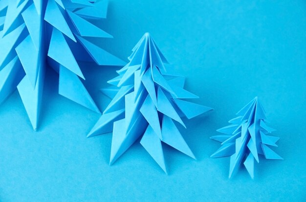 Blue paper origami christmas trees compostion