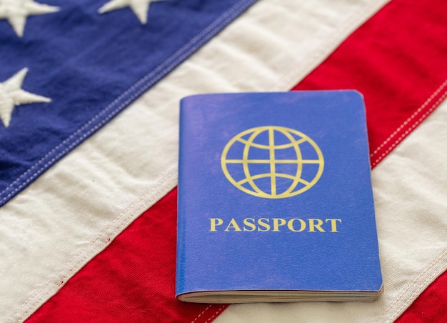 Blue passport on USA flag background close up view