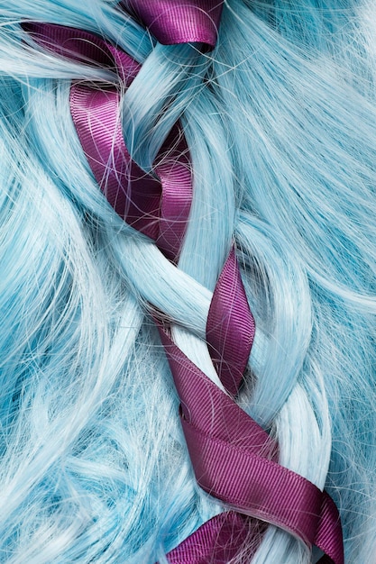 Blue pastel hair braded with purple silk ribbon closeup