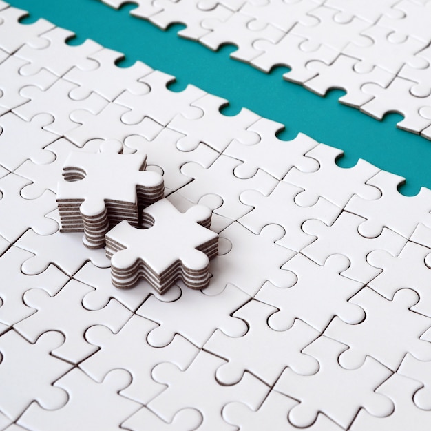 The blue path is laid on the platform of a white folded jigsaw puzzle